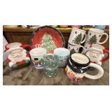 An assortment of Christmas coffee mugs and a bowl.