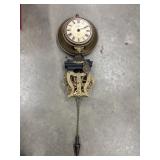 A vintage German skeleton wall clock features a