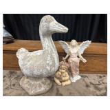 A cast stone duck garden ornament and Roman