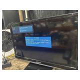 Samsung TV with remote and Roku device.