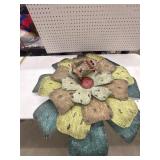 A rustic, layered metal flower wall art features