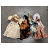 Corn husk doll and 3 international Dolls.