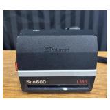 Polaroid Sun 600 LMS instant film camera and case.