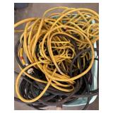 Bundle of extension cords , power stops and rope.