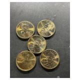 FIVE United States Sacagawea one-dollar coins.