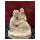 Boy and girl sitting chalkware figurine