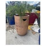 Terracotta planter with geometric designs.