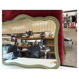 green-framed wall mirror