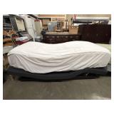 Twin size adjustable bed frame with mattress.