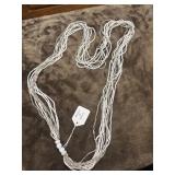 Multi-strand white and silver beaded necklace.