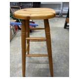 Solid wood bar stool with tapered legs.