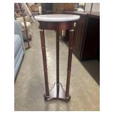 Vintage pedestal plant stand features a white