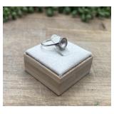 Sterling silver ring featuring a round, bezel-set