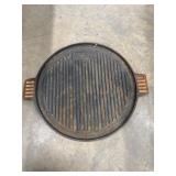 Outdoor Gourmet 14-inch round cast iron griddle.