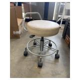 Beige shop rolling stool.