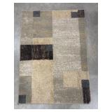 Modern geometric rug in brown and gray tones