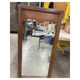 Tall, wooden wall mirror.