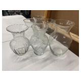 Collection of clear glass floral vases with