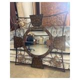 Decorative wrought-iron wall mirror with a