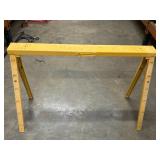 2 yellow, heavy-duty folding steel sawhorses.