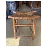 Vintage wooden low stool with a woven rush seat