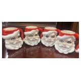 4 Vintage, hand-painted ceramic Santa head mugs.