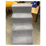 Grey corduroy-textured foam pet stairs.