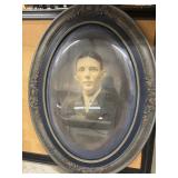 Antique oval portrait featuring a gentleman in a