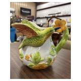 Decorative ceramic pitcher featuring a 3D