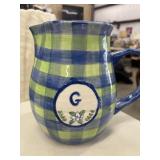 Pottery pitcher with initial G.
