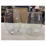 2 Clear, stemless glass vases.