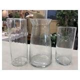 3 Clear glass vases of varying heights and