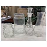 Collection of four assorted clear glass jars and