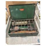 Vintage green Coleman two-burner liquid fuel camp