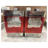 2 1-gallon red metal cans of Coleman Liquid Fuel.