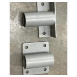 2 pc. metal T-shaped pipe mounting brackets.