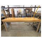 Work table with a light-colored wood top and