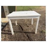 Simple, rectangular white wooden table.