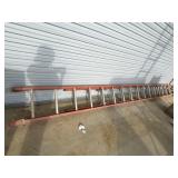 An orange fiberglass extension ladder with