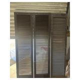Set of three tall, dark-stained wooden louvered