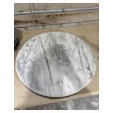 Round, polished white marble table top.