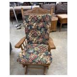 Traditional wooden glider rocker with a