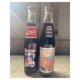 two vintage 10 fl oz commemorative Coca-Cola