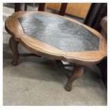 Octagon-shaped wooden coffee table with a slate
