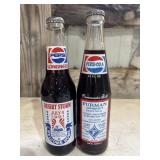 two vintage commemorative glass Pepsi bottles: a