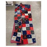 Handmade patchwork quilt with alternating red,