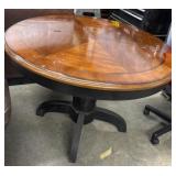 Round wooden pedestal dining table featuring a