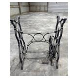 An antique cast-iron treadle sewing machine base.