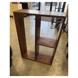 Open wooden shelf features a warm reddish-brown