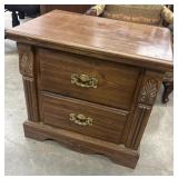 Vintage two-drawer wooden nightstand.